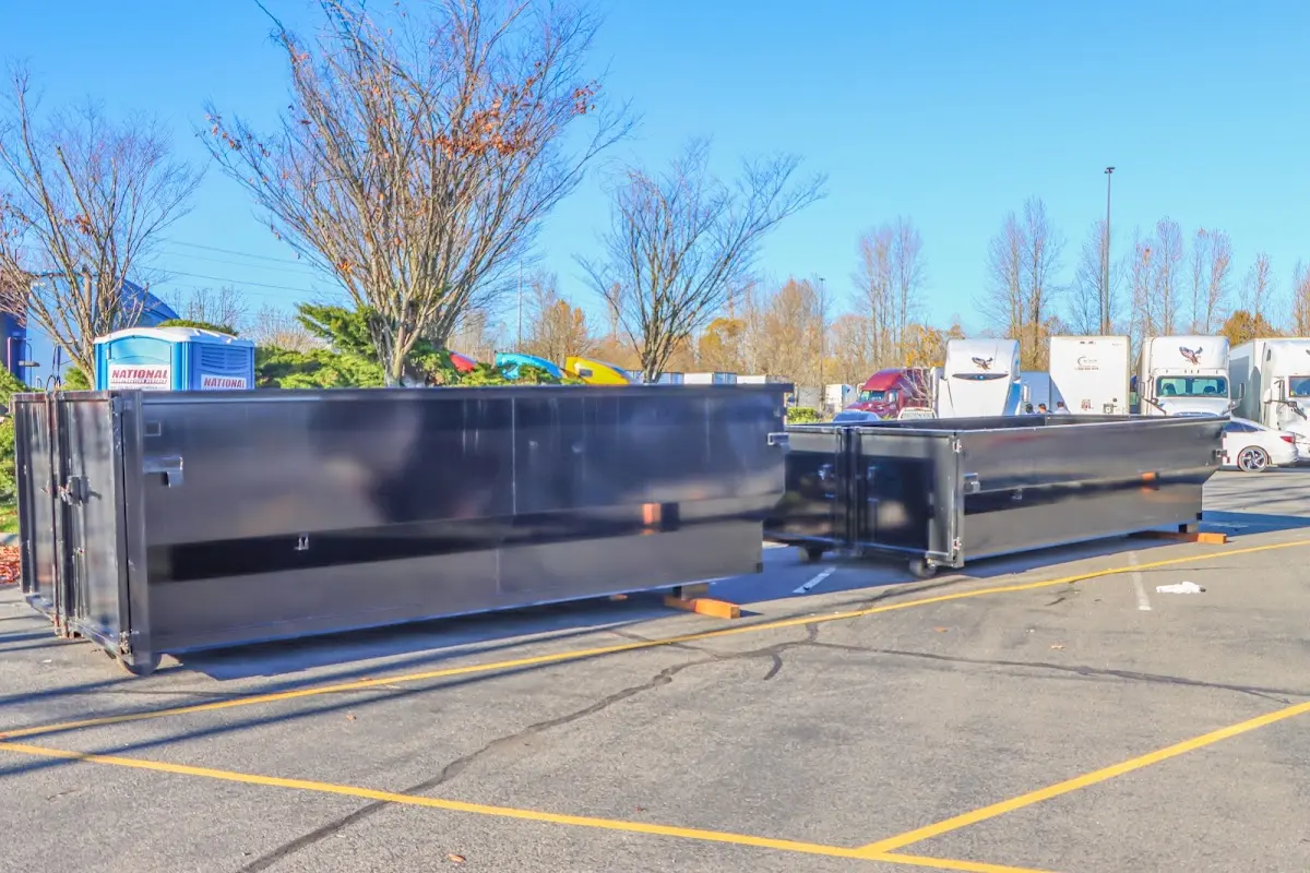 Professional dumpster rental service with roll-off container on residential driveway in Bethany